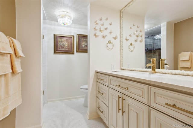 bathroom featuring toilet, baseboards, a shower, and vanity