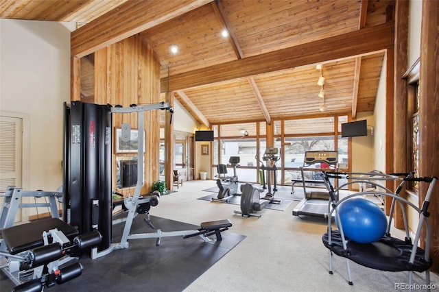 exercise room featuring high vaulted ceiling and wood ceiling