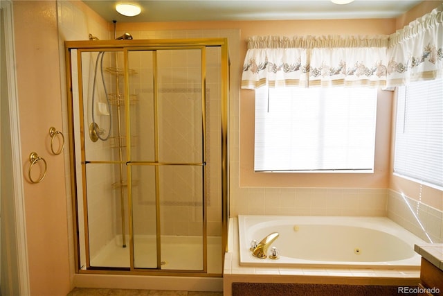 bathroom with vanity and shower with separate bathtub