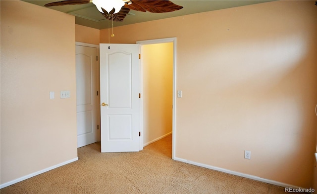 unfurnished bedroom featuring ceiling fan and light colored carpet