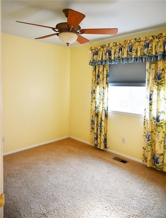 spare room with carpet flooring and ceiling fan