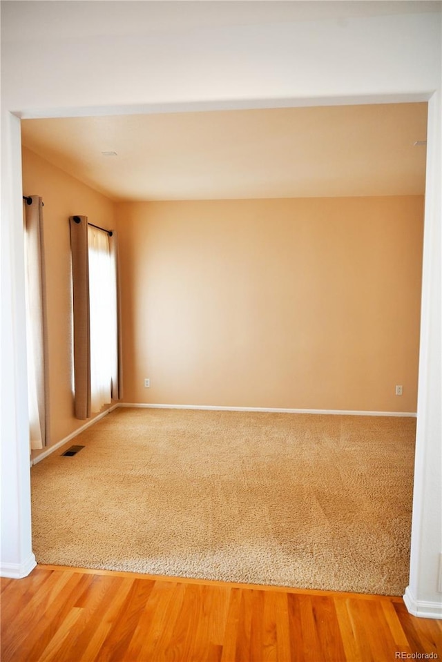 empty room with hardwood / wood-style flooring