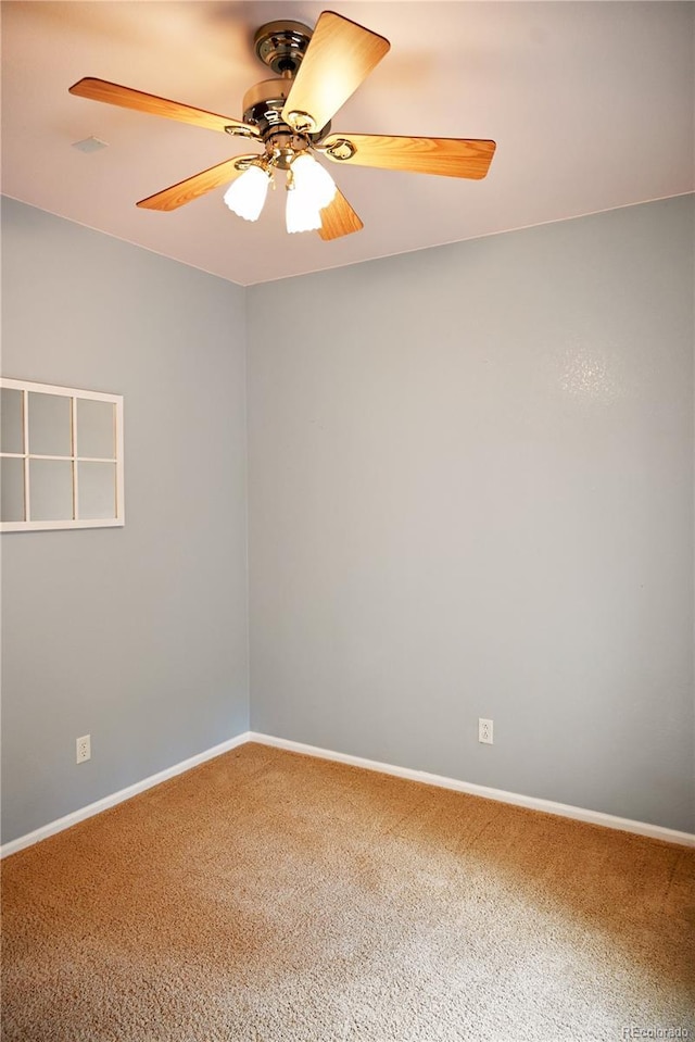 carpeted spare room featuring ceiling fan