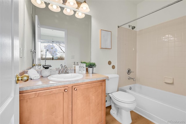bathroom featuring  shower combination, toilet, vanity, and wood finished floors