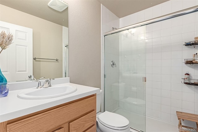 bathroom with vanity, walk in shower, and toilet