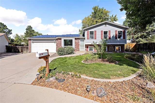 split level home featuring a garage and a front lawn