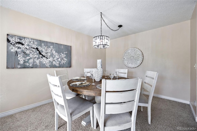 carpeted dining space with a textured ceiling and an inviting chandelier