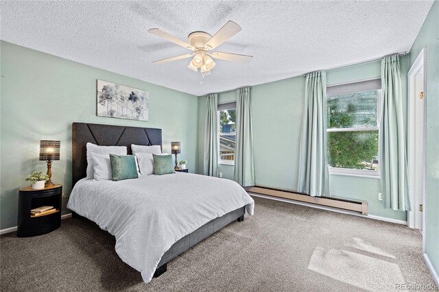 carpeted bedroom with a textured ceiling, baseboard heating, and ceiling fan