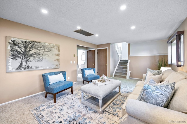 living room featuring a textured ceiling and carpet floors