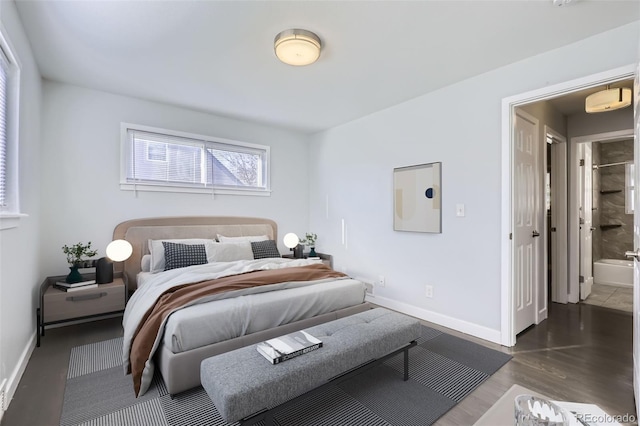 bedroom with ensuite bath and wood-type flooring