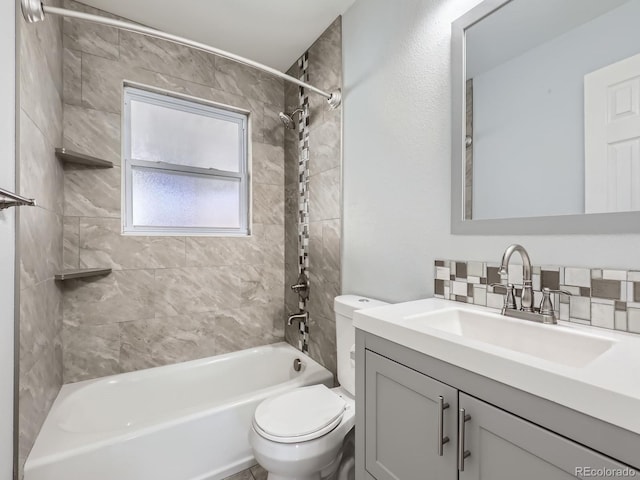 full bathroom with toilet, tiled shower / bath combo, and vanity