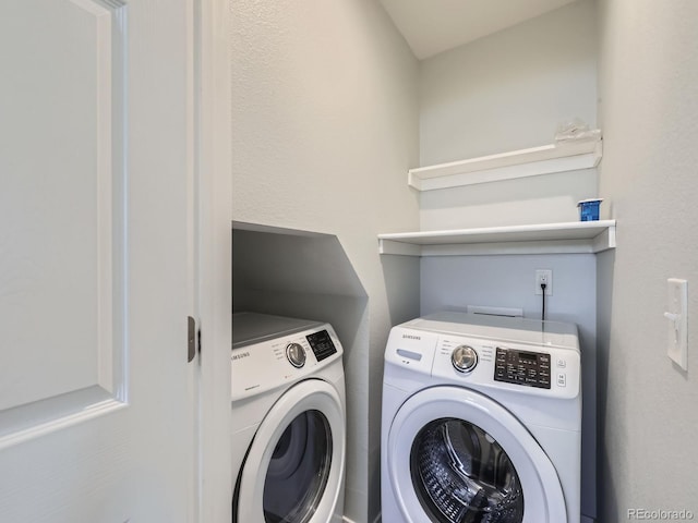 washroom featuring washing machine and dryer