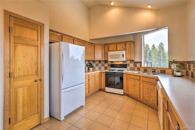 kitchen with white appliances, sink, decorative backsplash, and light tile patterned floors