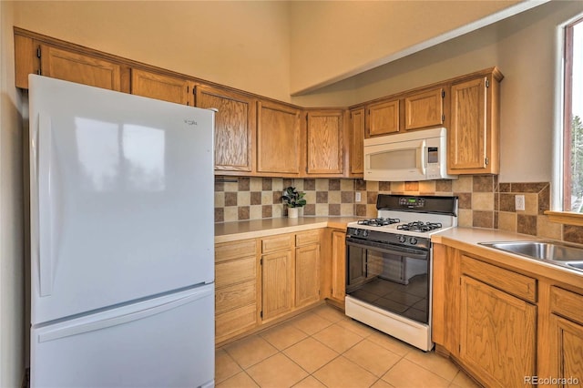 kitchen with white appliances, sink, decorative backsplash, and light tile patterned floors