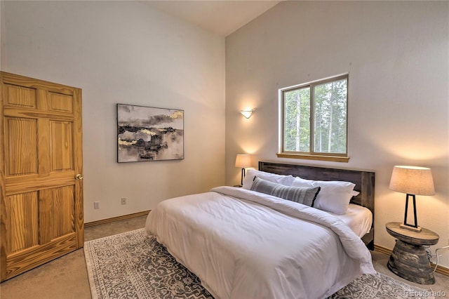 carpeted bedroom featuring high vaulted ceiling