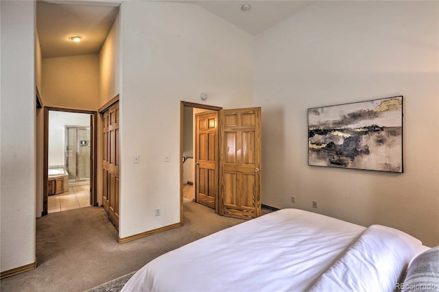 bedroom featuring high vaulted ceiling, ensuite bathroom, and carpet flooring