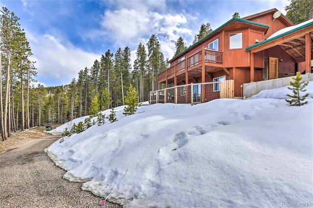 yard covered in snow with a wooden deck