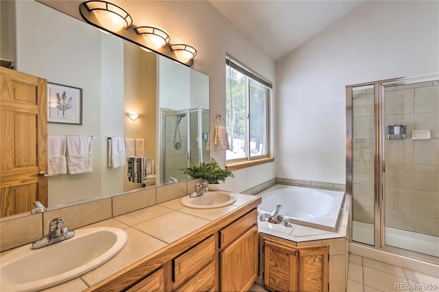 bathroom with tile patterned floors, lofted ceiling, separate shower and tub, and vanity