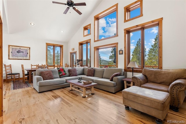 72 Overlook Ct, Idaho Springs, CO 80452 - living area featuring light wood-type flooring, ceiling fan, a wealth of natural light, and high vaulted ceiling