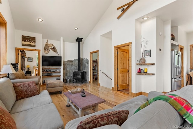 72 Overlook Ct, Idaho Springs, CO 80452 - living area featuring recessed lighting, a wood stove, light wood finished floors, and high vaulted ceiling