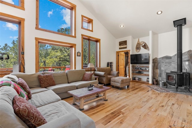 72 Overlook Ct, Idaho Springs, CO 80452 - living room with recessed lighting, high vaulted ceiling, wood finished floors, and a wood stove
