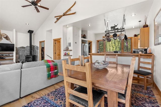 72 Overlook Ct, Idaho Springs, CO 80452 - dining space featuring ceiling fan, a wood stove, high vaulted ceiling, light wood-style flooring, and recessed lighting