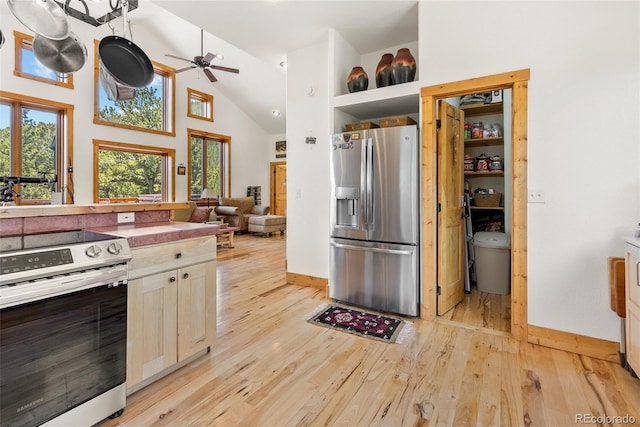 72 Overlook Ct, Idaho Springs, CO 80452 - kitchen with ceiling fan, open shelves, high vaulted ceiling, stainless steel appliances, and light wood-style flooring