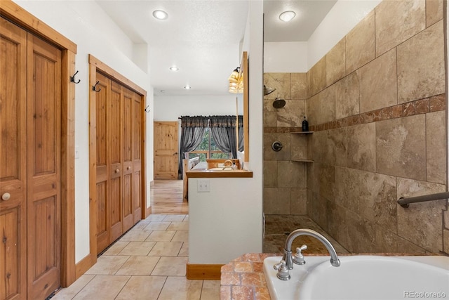 72 Overlook Ct, Idaho Springs, CO 80452 - bathroom featuring a tile shower, tile patterned flooring, recessed lighting, baseboards, and a bath