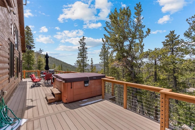 72 Overlook Ct, Idaho Springs, CO 80452 - wooden terrace with a hot tub, outdoor dining area, and a mountain view