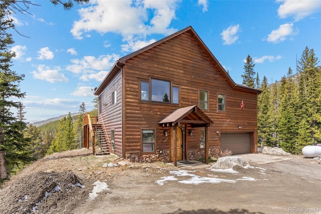 72 Overlook Ct, Idaho Springs, CO 80452 - chalet / cabin featuring a garage, stairway, and stone siding