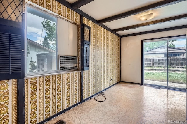 unfurnished sunroom with beamed ceiling