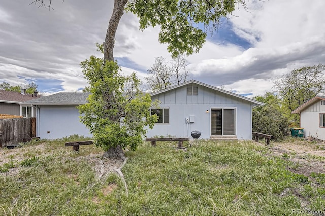rear view of property with fence