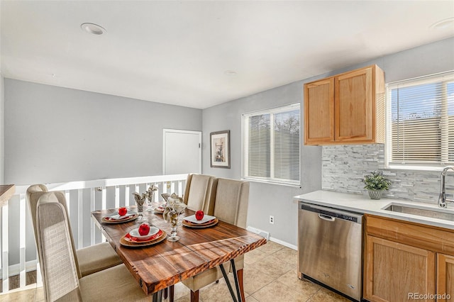 dining space featuring light tile patterned flooring and sink