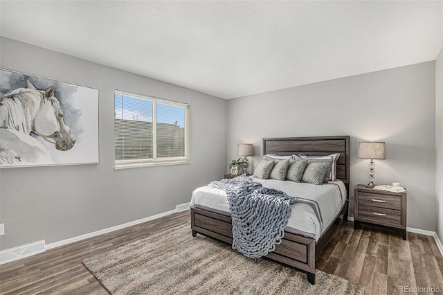 bedroom with dark wood-type flooring