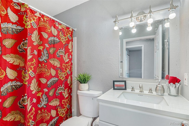 bathroom with vanity, toilet, and walk in shower