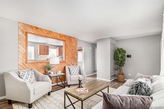 living room featuring wood walls and light hardwood / wood-style floors