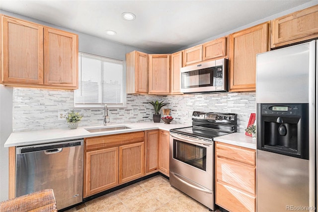 kitchen featuring backsplash, sink, light tile patterned floors, light brown cabinetry, and appliances with stainless steel finishes