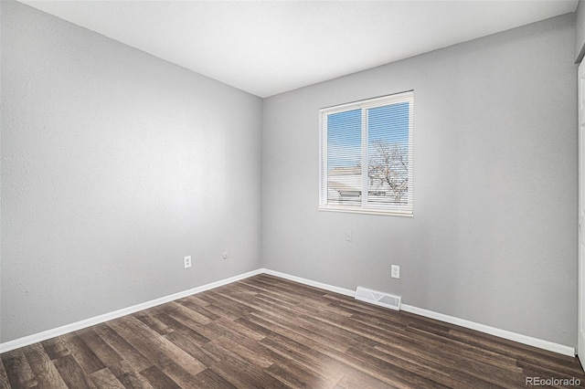 empty room with dark wood-type flooring