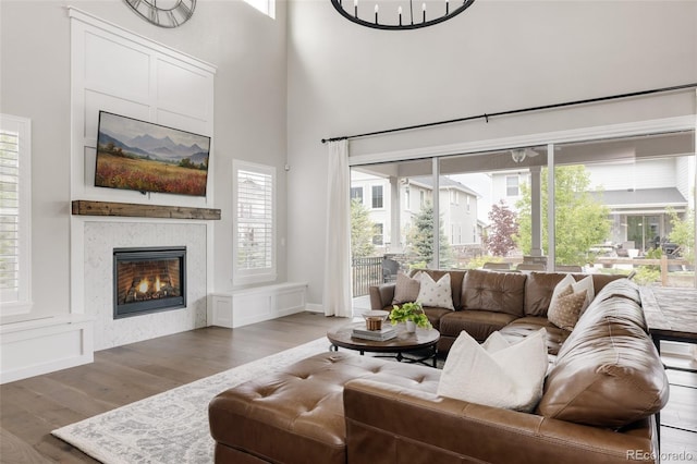 27653 E Euclid Dr, Aurora, CO 80016 - living room featuring wood finished floors, plenty of natural light, a fireplace, and a high ceiling
