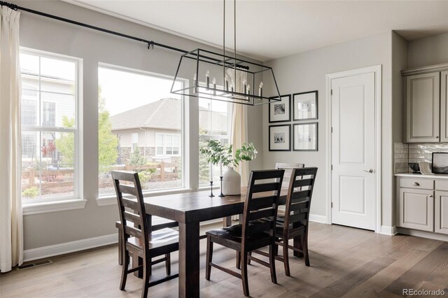 27653 E Euclid Dr, Aurora, CO 80016 - dining space featuring a chandelier, light wood finished floors, and baseboards