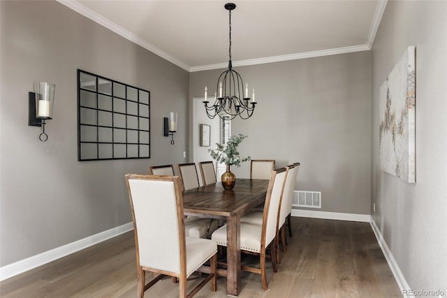 27653 E Euclid Dr, Aurora, CO 80016 - dining area featuring a chandelier, wood finished floors, crown molding, and baseboards