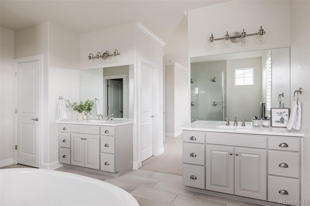 27653 E Euclid Dr, Aurora, CO 80016 - full bathroom with a shower stall, two vanities, a bath, and baseboards