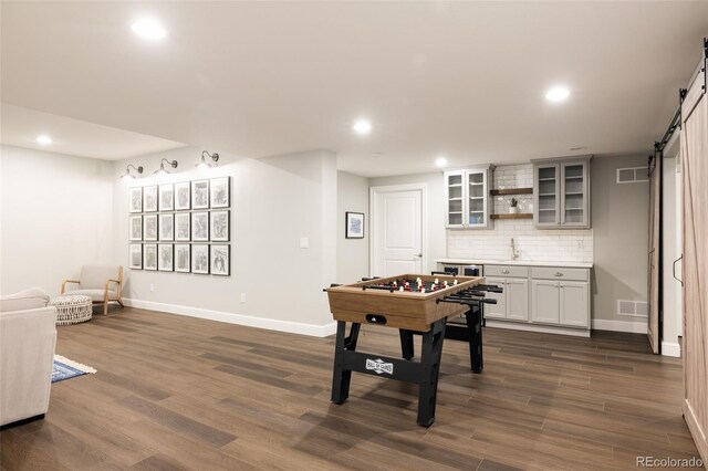 27653 E Euclid Dr, Aurora, CO 80016 - game room with a barn door, recessed lighting, baseboards, dark wood finished floors, and a sink