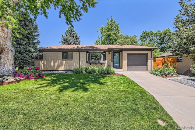 5525 E Bails Dr, Denver, CO 80222 - view of front of house with driveway, an attached garage, brick siding, and a front lawn