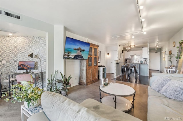 living room featuring sink and track lighting