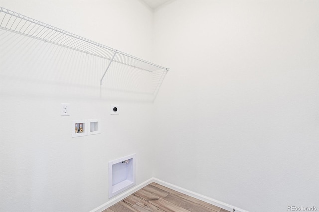 washroom with hookup for a washing machine, hookup for an electric dryer, and hardwood / wood-style flooring