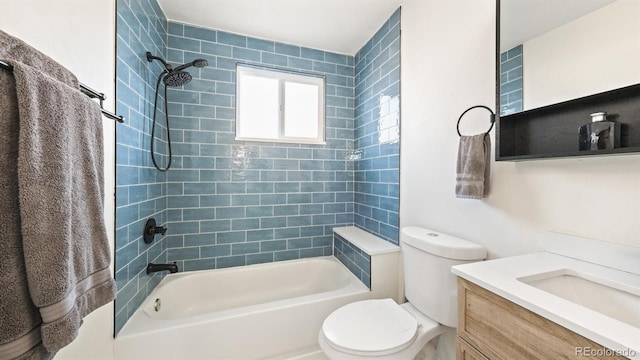 full bathroom with vanity, toilet, and tiled shower / bath