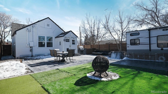 exterior space featuring a yard, a patio, and a fire pit