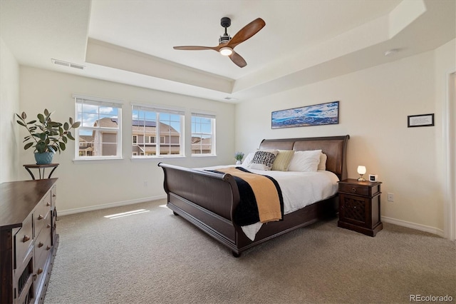 16341 Clayton St, Thornton, CO 80602 - carpeted bedroom with a raised ceiling, multiple windows, and a ceiling fan