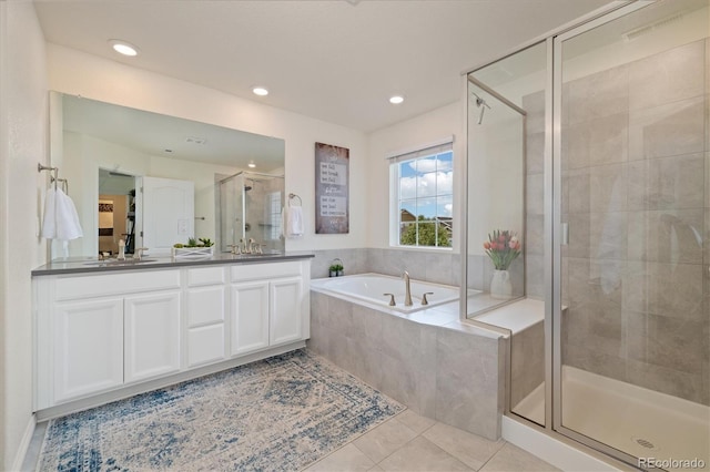 16341 Clayton St, Thornton, CO 80602 - bathroom featuring a stall shower, double vanity, a bath, tile patterned floors, and recessed lighting